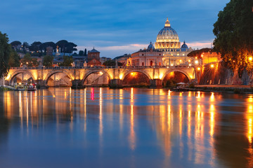 Fototapeta na wymiar Saint Peter Cathedral and Saint Angel bridge over the Tiber River during morning blue hour in Rome, Italy.