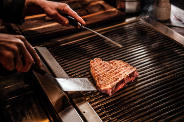 Close-up image of a cooking delicious meat steak on a grill