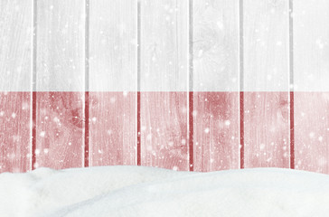 Christmas winter background with wooden wall, falling snow, snowdrift and Polish flag
