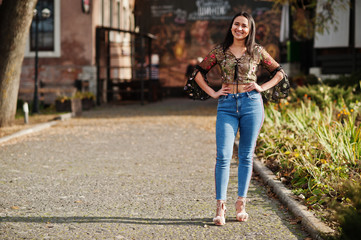 Pretty latino model girl from Ecuador wear on jeans posed at street.