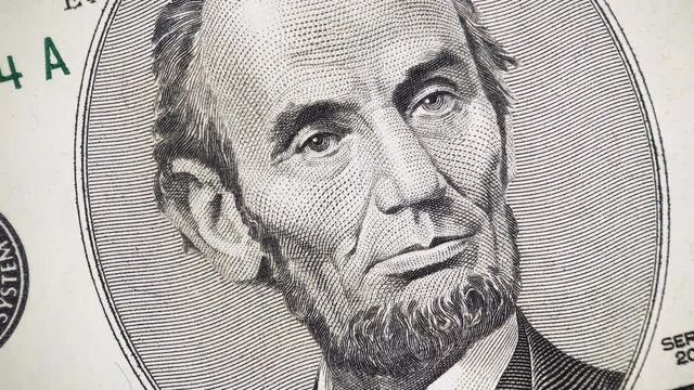 US President Abraham Abe Lincoln face on 5 dollar bill rotate, 4K ultra hd video