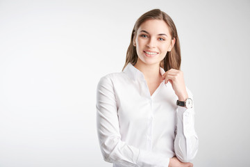 Portrait of an attractive young woman standing against white background