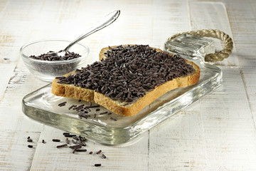 Dutch white bread with hagelslag (chocolate sprinkles) topping on glass board
