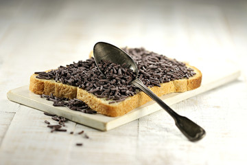 Dutch white bread with hagelslag (chocolate sprinkles) topping on ceramic board