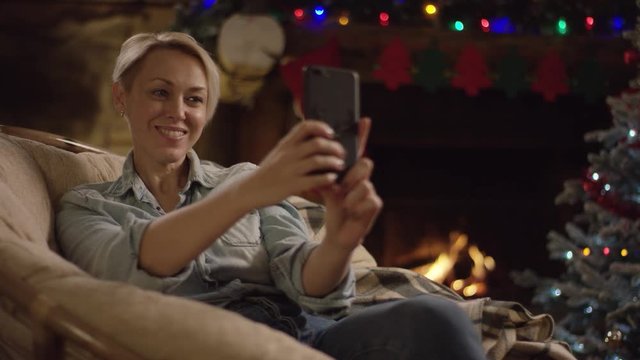 Blond attractive woman takes selfie in Christmas night