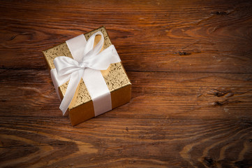 one decoratively wrapped gift on a wooden table