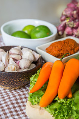 Fresh herbs and spices (chili, garlic, lettuce, lemon, cucumber)