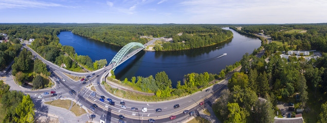 Aerial view of Merrimack River and Tyngsboro Bridge panorama in downtown Tyngsborough, Massachusetts, USA.