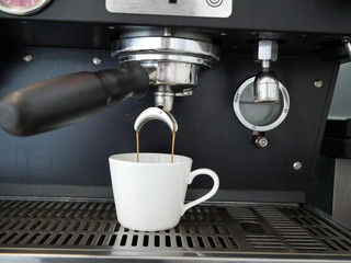 Espresso Being Extracted from Commercial Coffee Machine