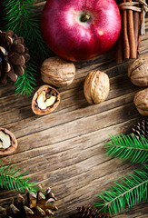 Christmas holiday background with fir branches, pine cones and nuts.