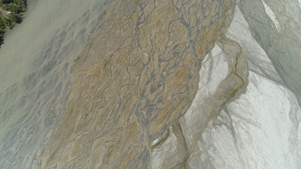 Fototapeta premium Parched river in mountain province Luzon, Philippines. Aerial view Drought in mountain valley, dry and shallow Bucao river.