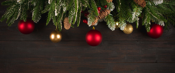 Christmas background with fir tree green branches, greeting card with decoration in red and golden...