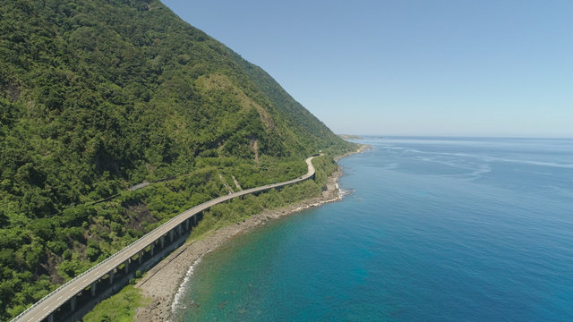 Aerial view of Patapat viaduct in the coast of Pagudpud, Ilocos Norte. Highway with bridge by coast sea near the mountains. Philippines, Luzon. Highway along the coast.