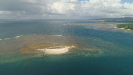 Tropical island with white sandy beach. Aerial view of sandy Crocodile island with colorful reef. Santa Ana Seascape, ocean and beautiful beach. Philippines. Travel concept.