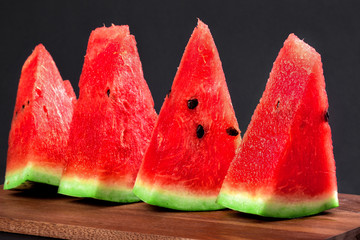 Four triangular wedges of watermelon