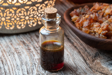 A bottle of myrrh essential oil with myrrh resin