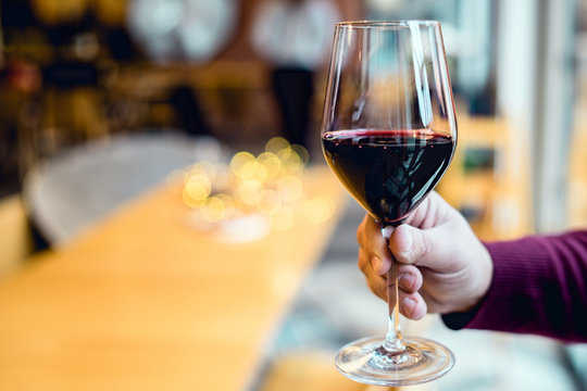 Close Up On Hand Holding A Glass Of Red Wine