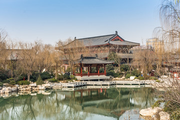 Fototapeta na wymiar HUAQING, CHINA, 25 DECEMBER 2017: Landscape of a lake and a traditional chinese temple in Huaqing Palace