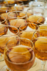 Wine glasses and orange juice glass on a white table background