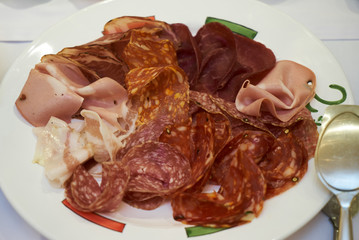 Cold smoked meat plate with sliced pork, prosciutto, salami, ham