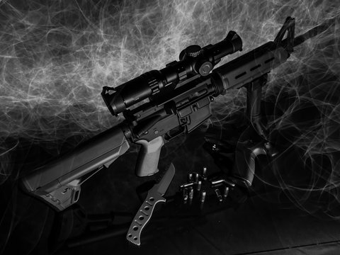 Light painting image done in black and white featuring a rifle, handgun, and tactical knife.