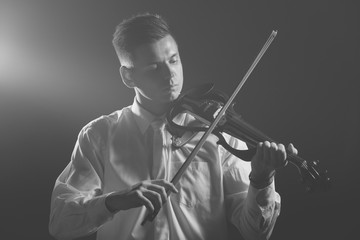 The musician plays the electronic violin. Violin close up. 