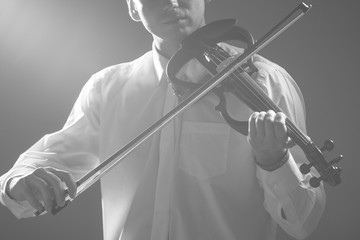 The musician plays the electronic violin. Violin close up. 