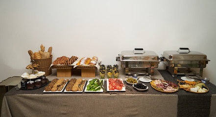 Catering wedding buffet food table on gray wall background 
