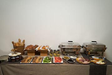 Catering wedding buffet food table on gray wall background 