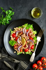 Tuna salad with tomatoes and white bean.Top view with copy space.