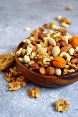 Wooden bowl with nuts ( pistachio, walnut, hazelnut, cashew, almond)  and dried fruits.