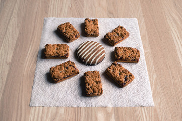 The cookie is on a napkin on the table.