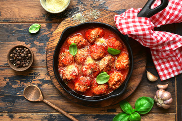 Meatball in a tomato sauce in a skillet pan.Top view with copy space.