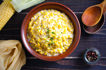 Sweet and creamy corn in bowl. Corn dish. overhead, horizontal