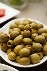 Assortment of fresh olives on a plate, close-up. Healthy snack f