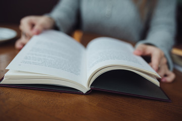 Woman reading book close up