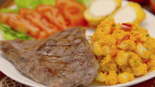 Meat Steak with corn tomatoes, lettuce and potatoes