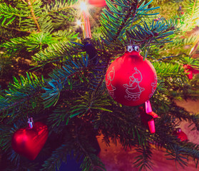Christmas bauble on a Christmas tree and glowing lights