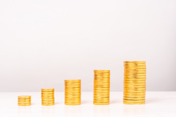 Piles of golden coins on white background. Saving money concept.