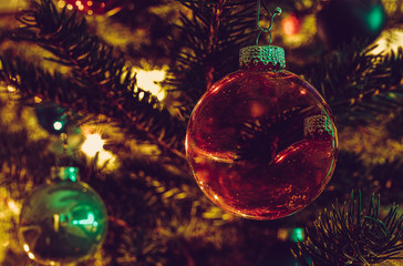 Christmas bauble on a Christmas tree and glowing lights