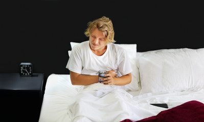 Young man in bed at home