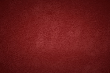 Fototapeta premium Red tone wall texture abstract background. Christmas background with copy space and darker vignette.