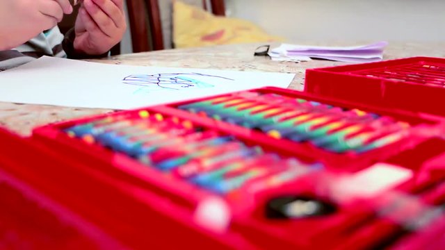 Boy drawing with a felt tip pen on the paper