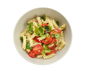 Tasty pasta salad with basil and fresh tomatoes on white background