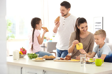 Happy family having breakfast together in kitchen