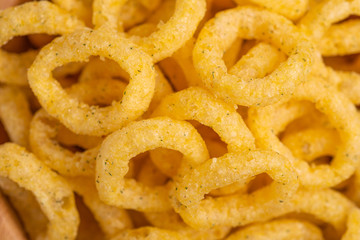 Puff corn rings backgroung. Snacks for watching movies