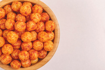Full wooden bowl of bacon corn puff balls