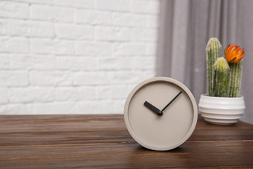 Modern alarm clock on table indoors. Space for text