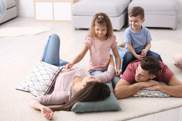 Happy family with pillows at home