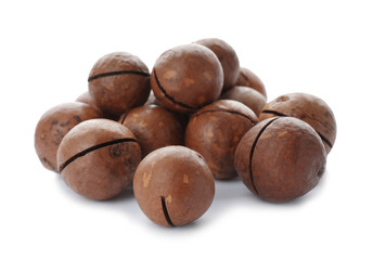 Pile of organic Macadamia nuts on white background